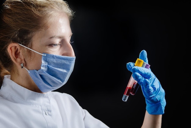 A medical worker is a doctor or nurse who works late a female doctor is holding test tubes and exami