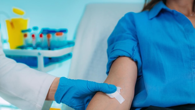 Medical Worker Taking Blood Sample from Patient in the Hospital