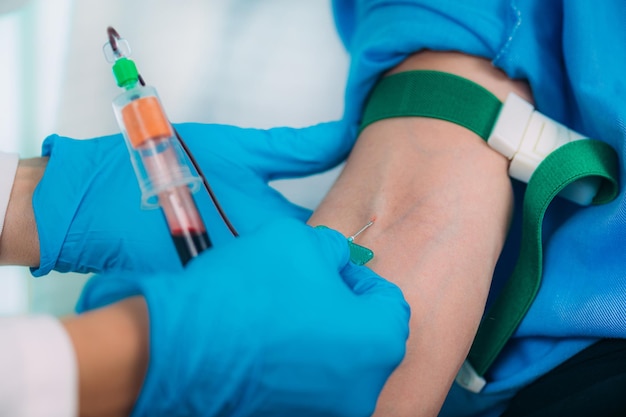 Medical Worker Taking Blood Sample from Patient in the Hospital