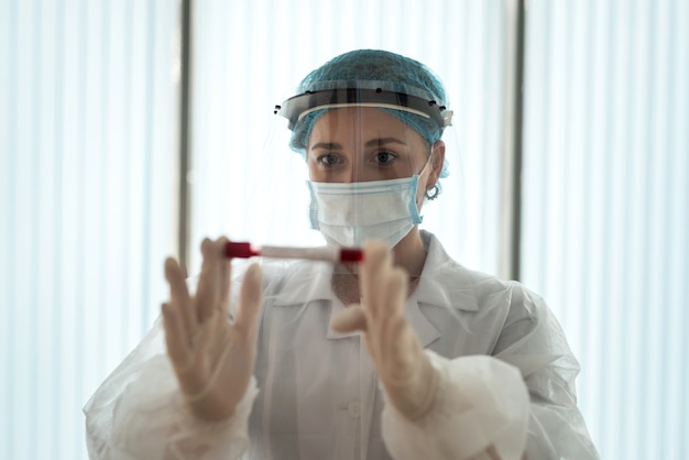 Medical worker testing patien blood samples for presence of coronavirus in laboratory