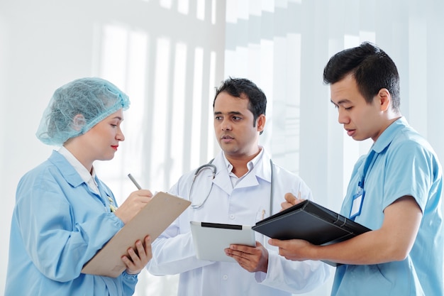 Medical workers listening to chief physician