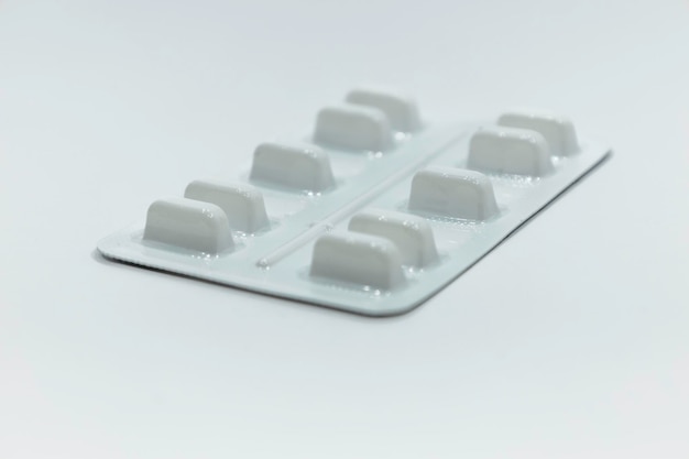 Photo medications pills in the blister pack on white background.