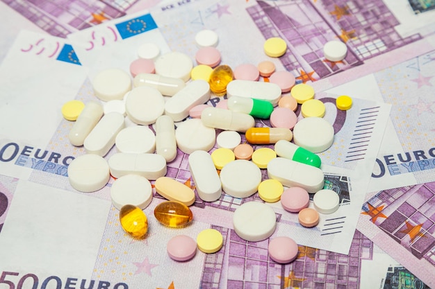 Medicijnpillen over eurobankbiljetten covid coronavirus pillen zijn op het eurobankbiljet het concept