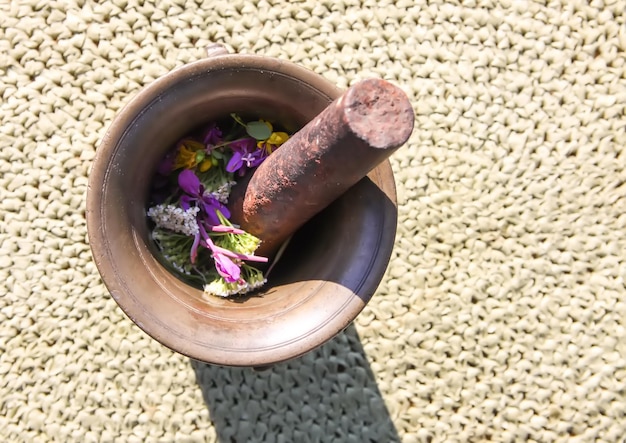 Medicinal herbs and flowers in a cooper mortar