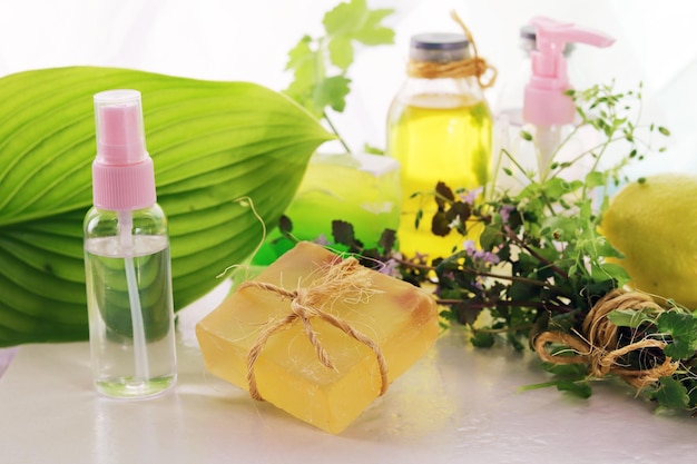 Medicinal herbs natural soap tincture and aromatic oil on a wooden table the concept of spa