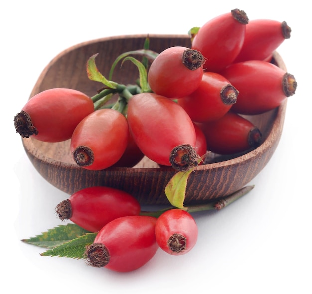 medicinal rose hips over white background
