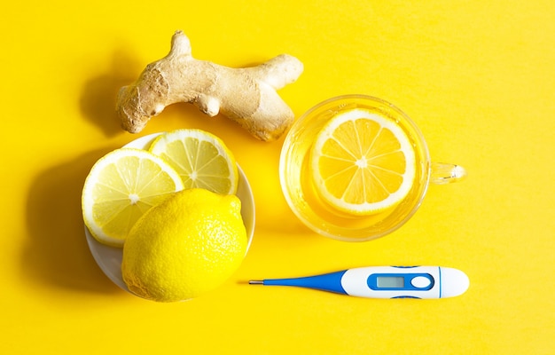 Medicinal tea in cup, ginger and lemons. top view, flat lay