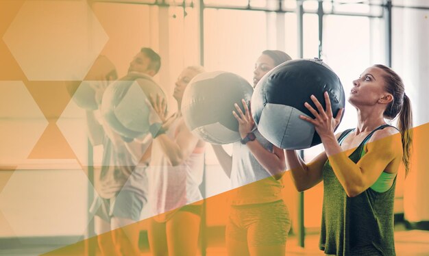 Photo medicine ball group of people and fitness exercise at gym for strong muscle and commitment athlete women and a man together for training workout or power challenge with overlay at a diversity club