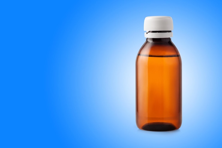 Photo medicine bottle of brown plastic on blue background