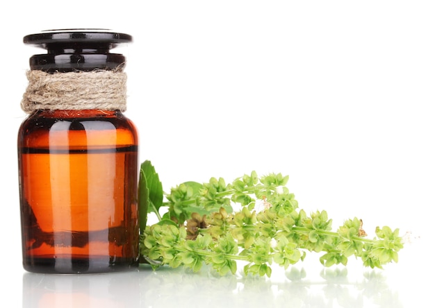 Medicine bottle and flowers isolated on white