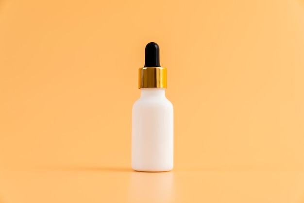 medicine bottle placed, blank label package for mockup on the orange background. the concept of natural beauty products.