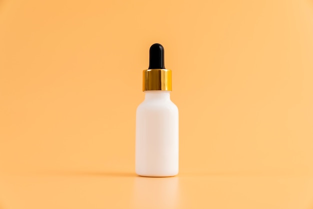 Medicine bottle placed, Blank label package for mockup on the orange background. The concept of natural beauty products.