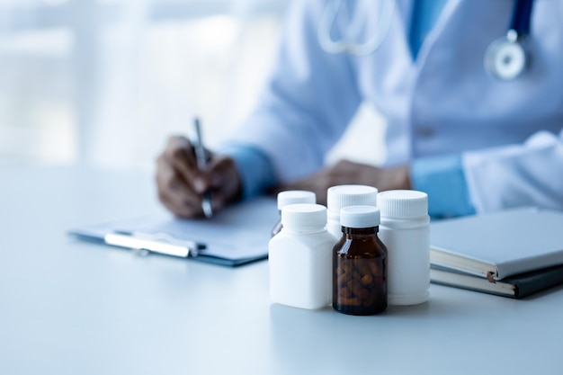 Photo medicine bottles are placed on the doctor's desk in the hospital examination room the concept of treatment and symptomatic medication dispensing by the pharmacist