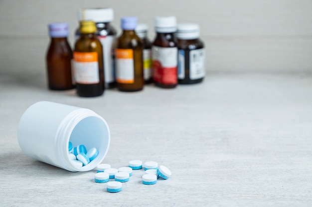 Medicine bottles and pill on the table