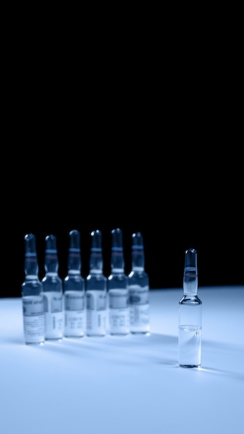medicine bottles on table against black background