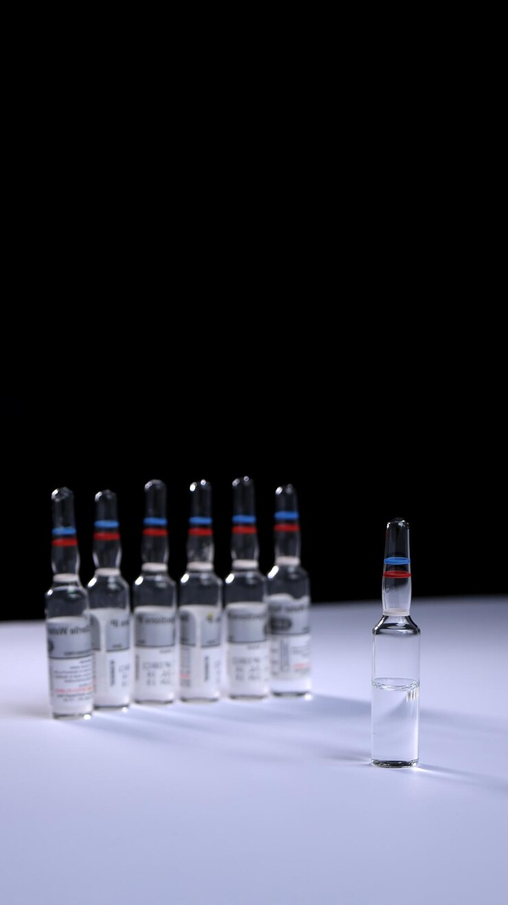 Photo medicine bottles on table against black background
