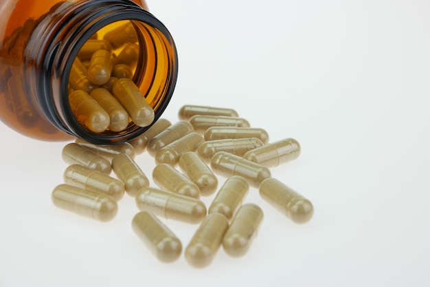 Medicine in a brown bottle on a white background.