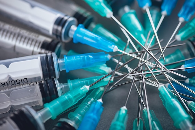 Medicine A bunch of different syringes over a grey background