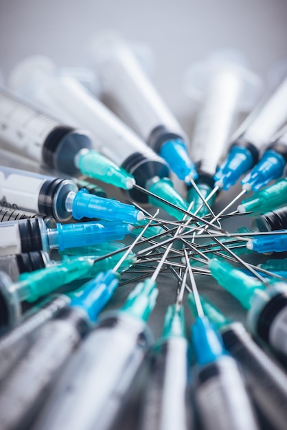 Medicine A bunch of different syringes over a grey background