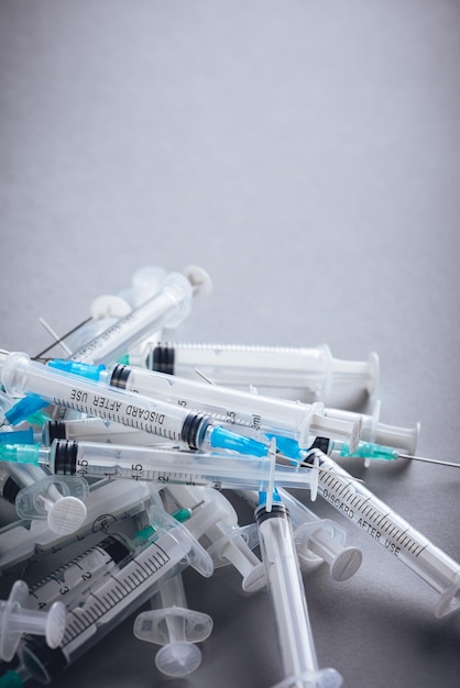 Medicine A bunch of different syringes over a grey background