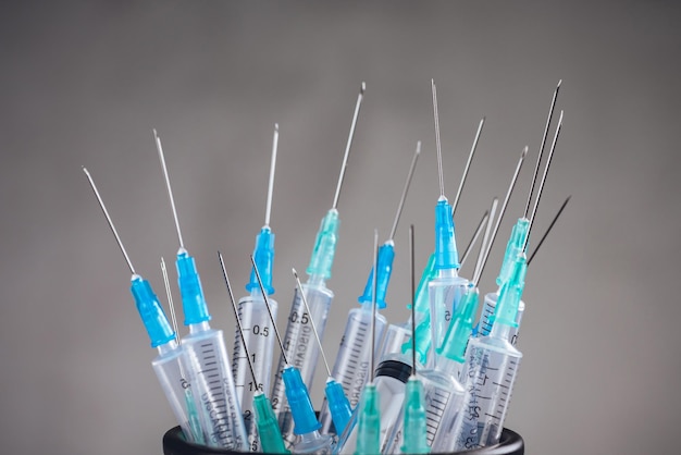 Medicine A bunch of different syringes over a grey background