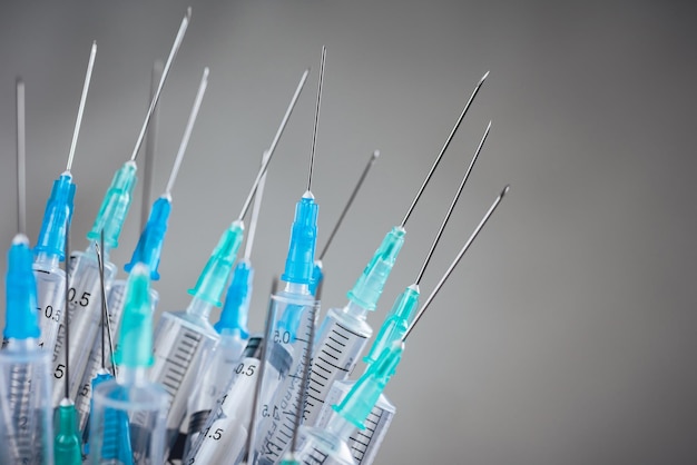 Medicine A bunch of different syringes over a grey background