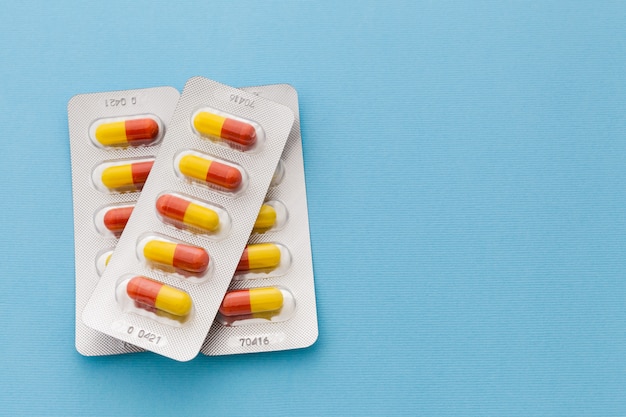 Medicine in capsules on a blue background