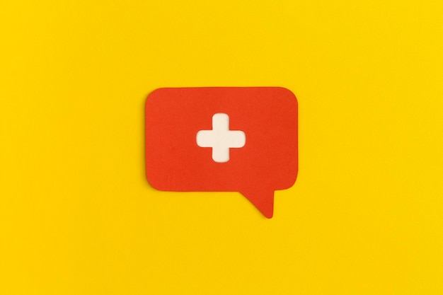 Medicine cross on a yellow background. Health and medical treatment concept.