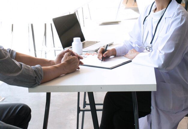 medicine doctor explain diagnosis to doctor team holding and showing clipboard exploring important document.