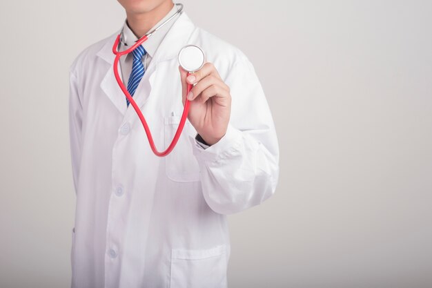 Medicine doctor hand holding stethoscope and working with modern medical icons