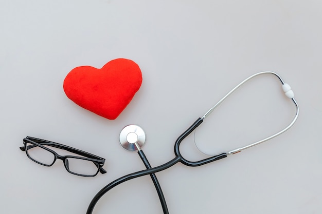 Medicine equipment stethoscope glasses and red heart isolated on white background