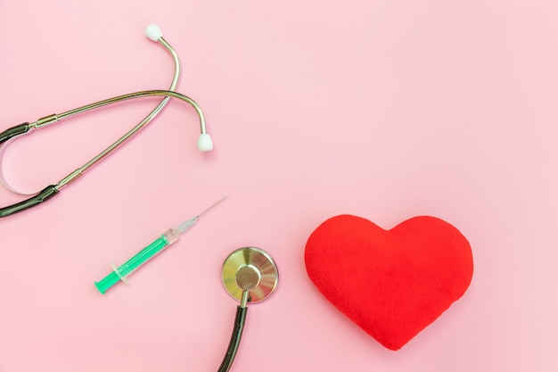 Medicine equipment stethoscope syringe isolated on pink background