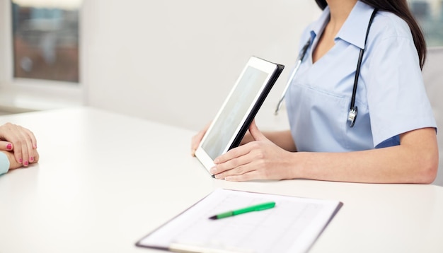 medicine, health and hospital concept - close up of female doctor showing to patient x-ray of spine on tablet pc computer screen