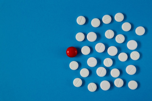 Medicine and health pills on blue table from above