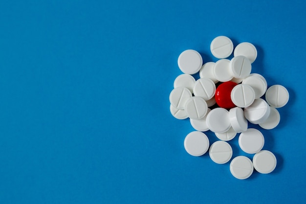 Medicine and health slide of pills on blue background from above