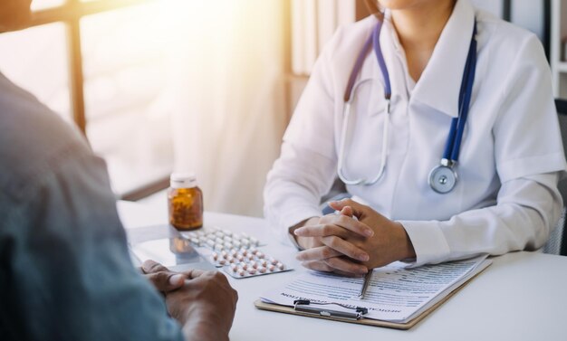 Medicine healthcare and people concept female doctor with tablet pc computer talking to smiling woman patient at hospital