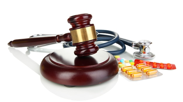 Medicine law concept. Gavel, stethoscope and pills isolated on white