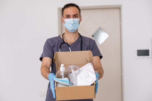 Medicine man courier in mask and gloves with medical pills purchases during the prevention of coronovirus, Safety home and quarantine concept, Volunteer with Donation goods.