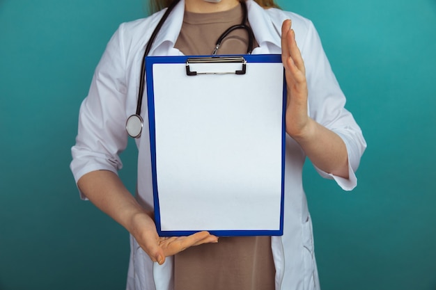 Medicine news concept. Woman doctor with tablet in the lab coat.