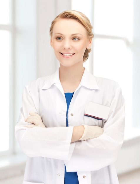 medicine, people, profession and healthcare concept - smiling young female doctor in white coat in hospital