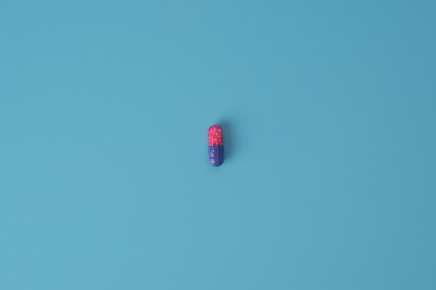 Photo medicine pill on blue surface