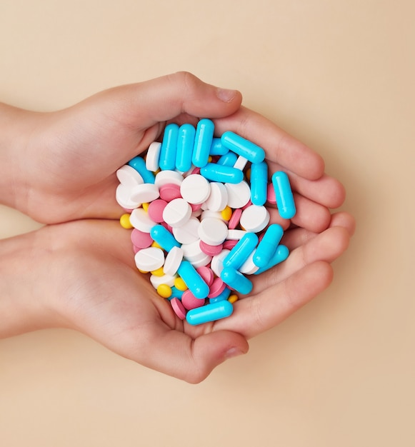 Medicine pills or capsules in hand. Medicine concept and health.