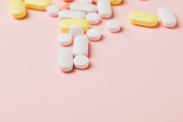 Medicine and pills on a pink background