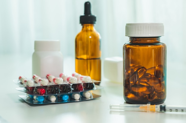 Medicine pills tablets and capsules on table