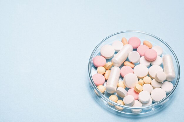 Medicine researching pharmaceutical background Many different drugs pills and tablets in a glass laboratory jar