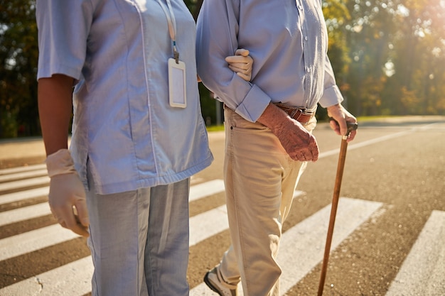 Medicine worker helping to the elderly man