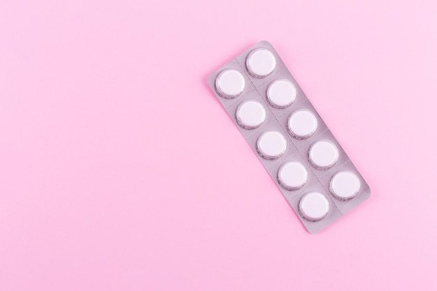 Medicines in packaging on a pink background Flatlay women's health treatment therapy contraception