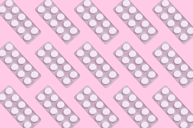 Medicines in packaging on a pink background Flatlay women's health treatment therapy contraception