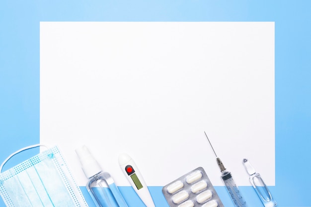 Medicines and a white sheet for a prescription on a blue background.