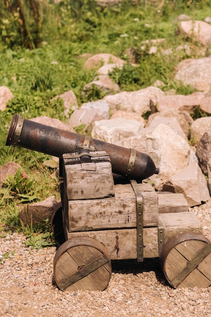 Medieval artillery piece on a wooden carriage standing outside in sunny weather